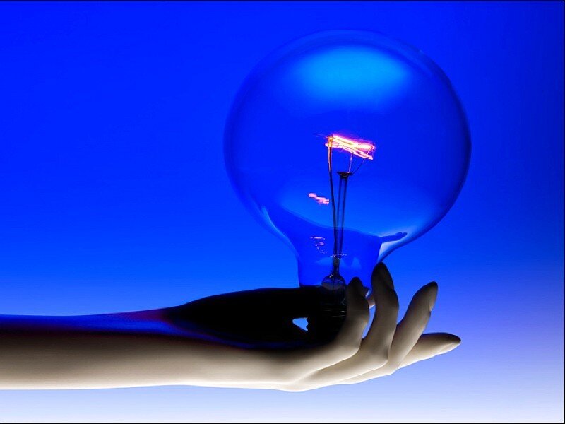 hand holding light bulb