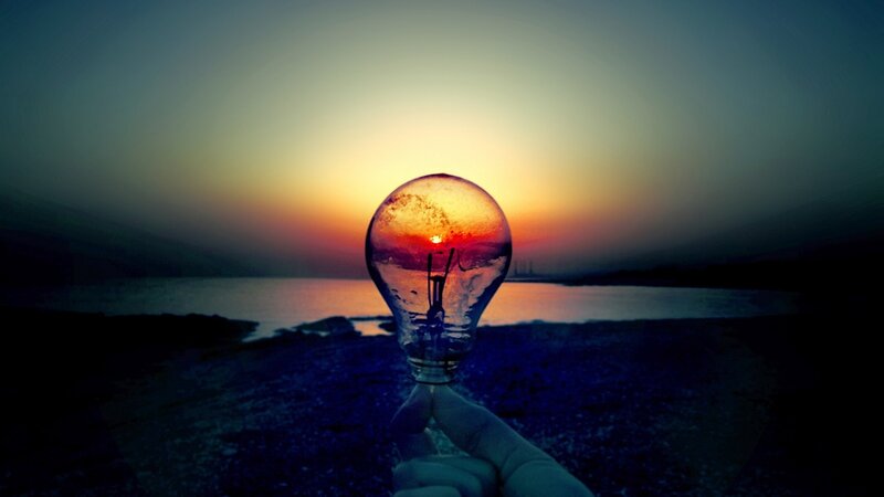 Hand Holding Light Bulb — Blue, Dramatic, Sunset, Photograph