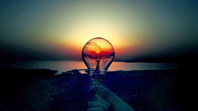 Hand Holding Light Bulb — Blue