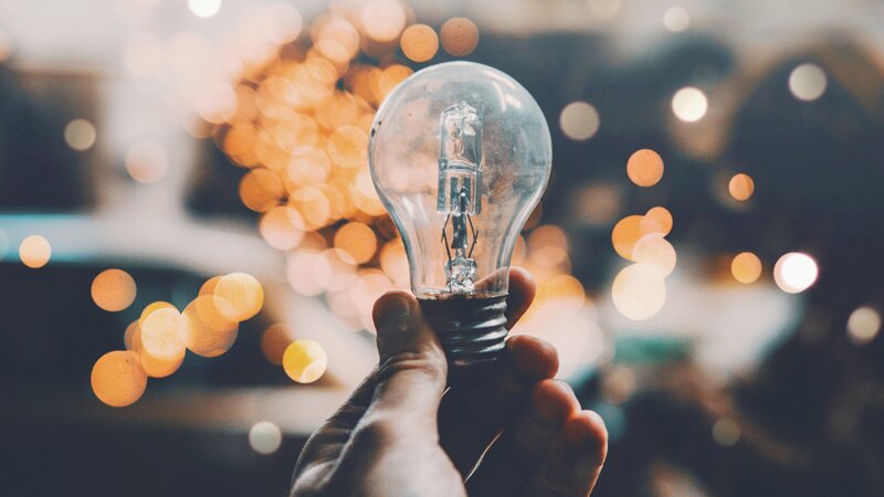 Hand Holding Light Bulb — White