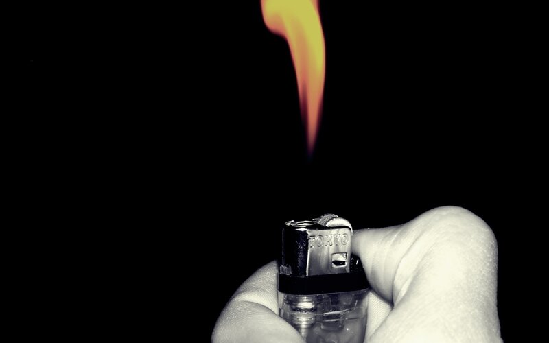 Hand Holding Lighter — Black, Dramatic, Photograph