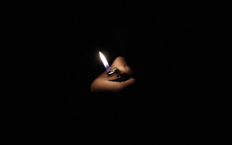 Hand Holding Lighter — Black, Dramatic