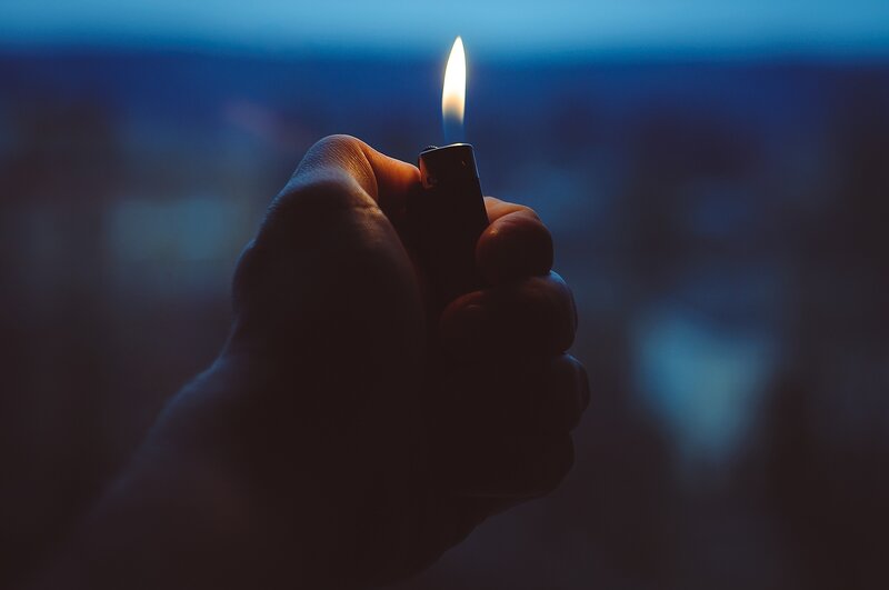 Hand Holding Lighter — Blue