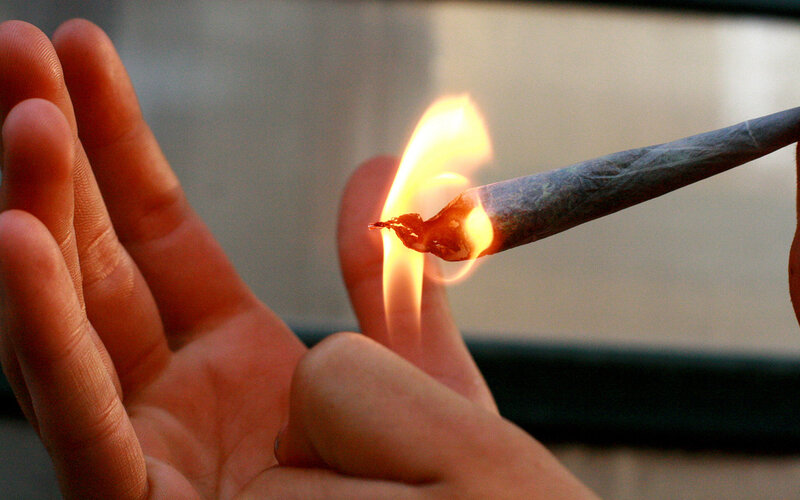hand holding lit joint