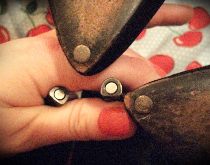 Hand Holding Metal Stamps