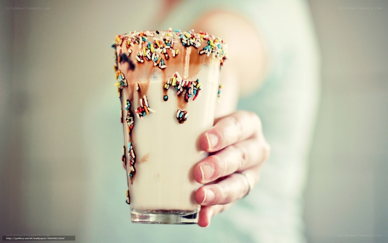 hand holding milkshake with sprinkles