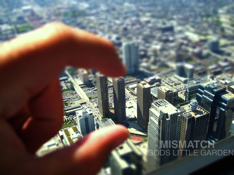 Hand holding miniature cityscape
