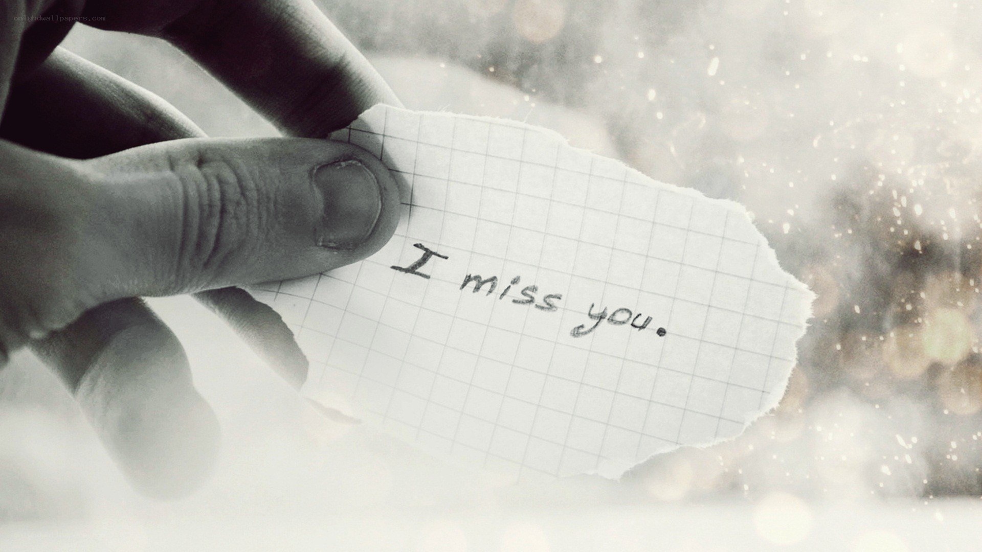 hand holding note saying i miss you
