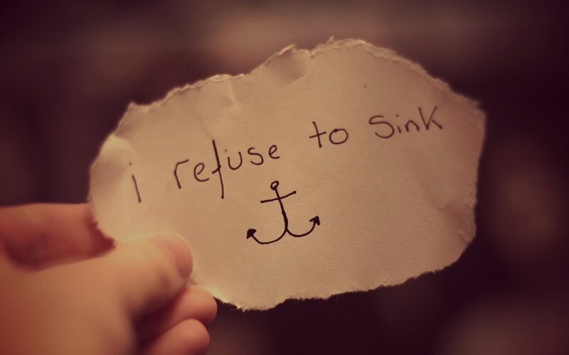 hand holding note with anchor