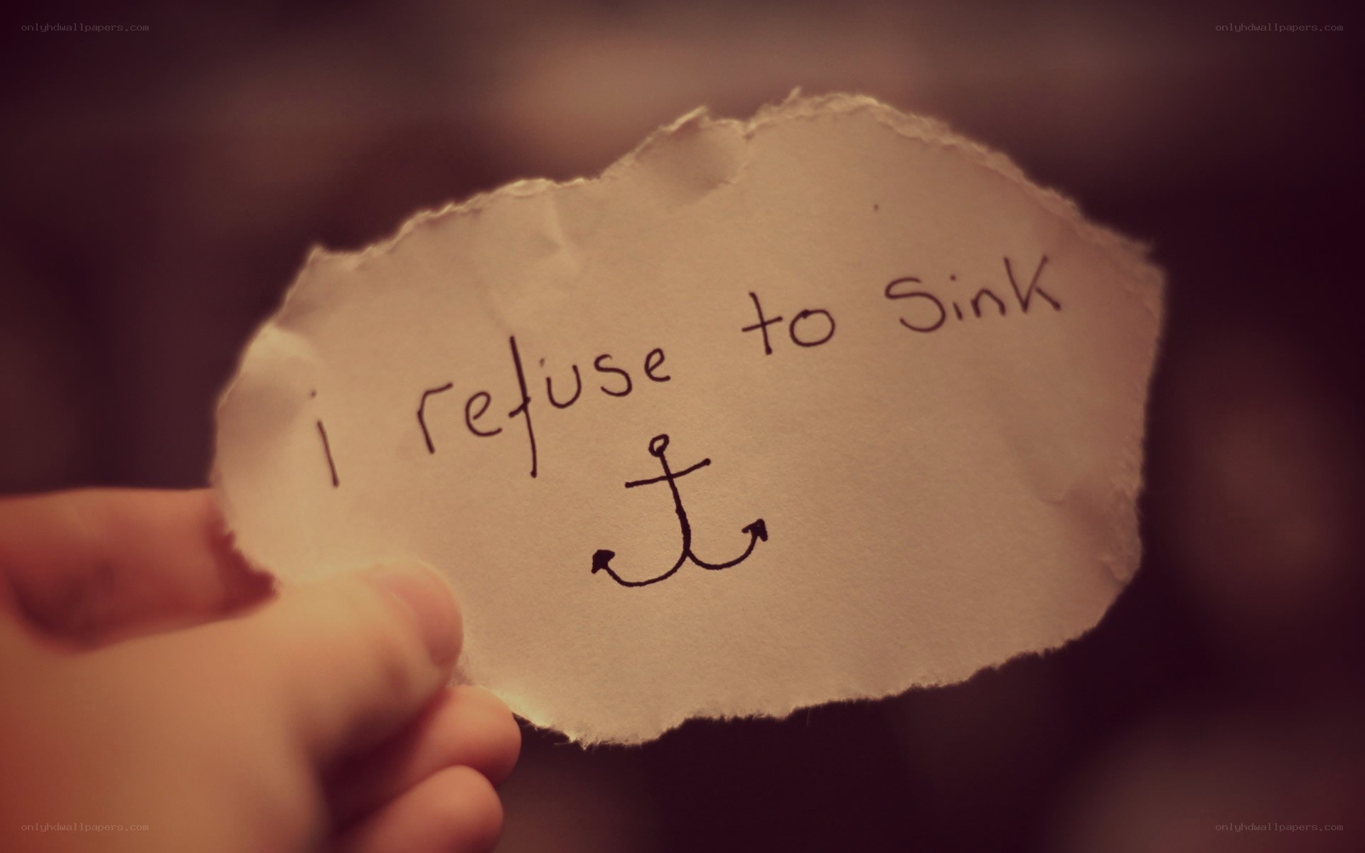 hand holding note with anchor