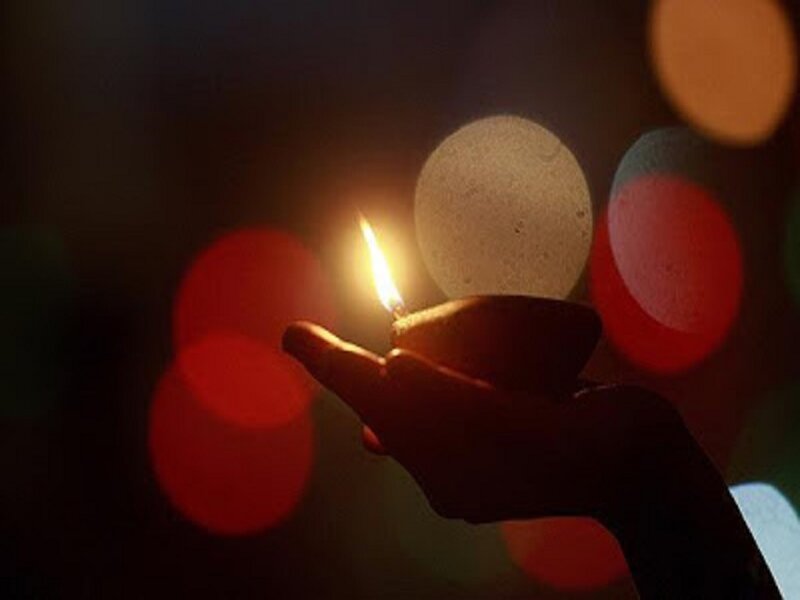 Hand Holding Oil Lamp