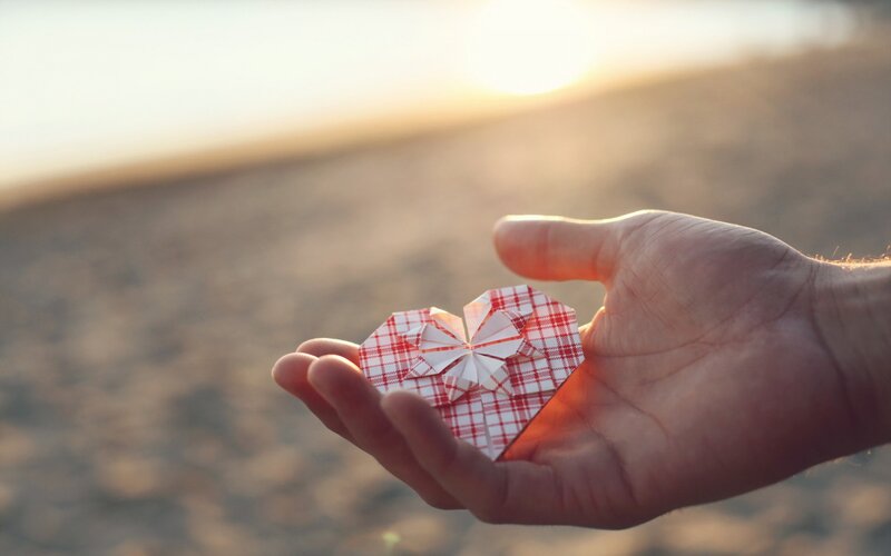 Hand Holding Origami Heart — Red
