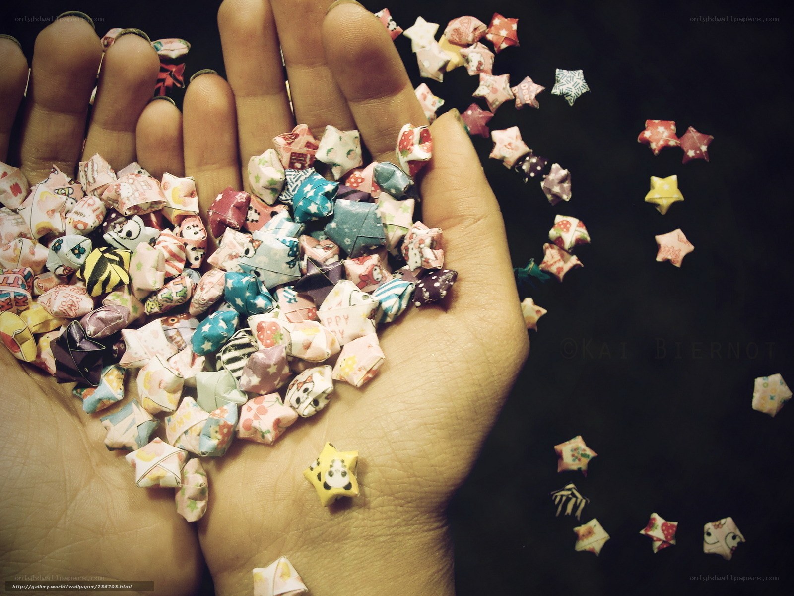 hand holding origami stars