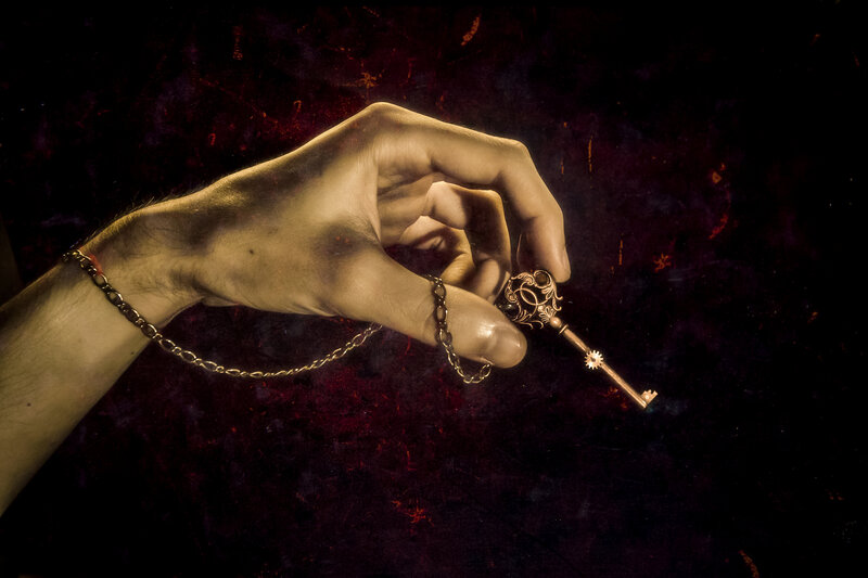 Hand Holding Ornate Key