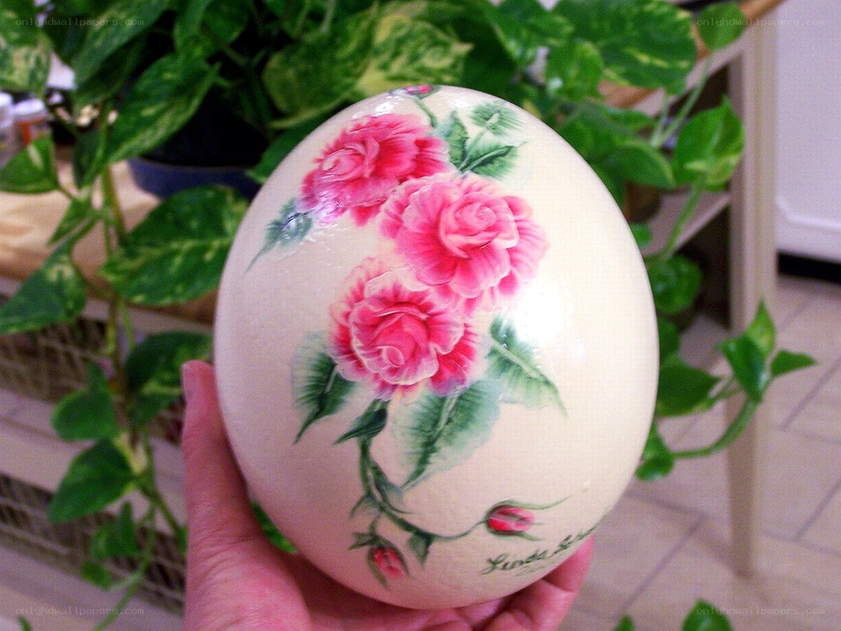 Hand holding painted ostrich egg