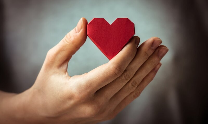 Hand Holding Paper Heart — Red