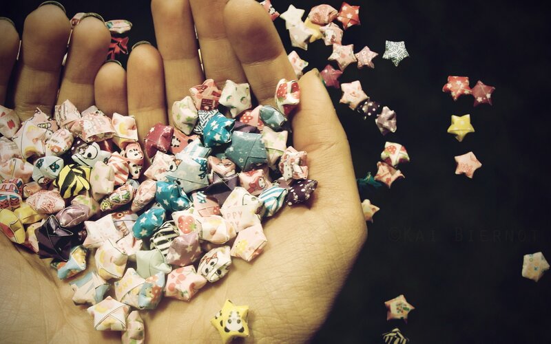 hand holding paper stars