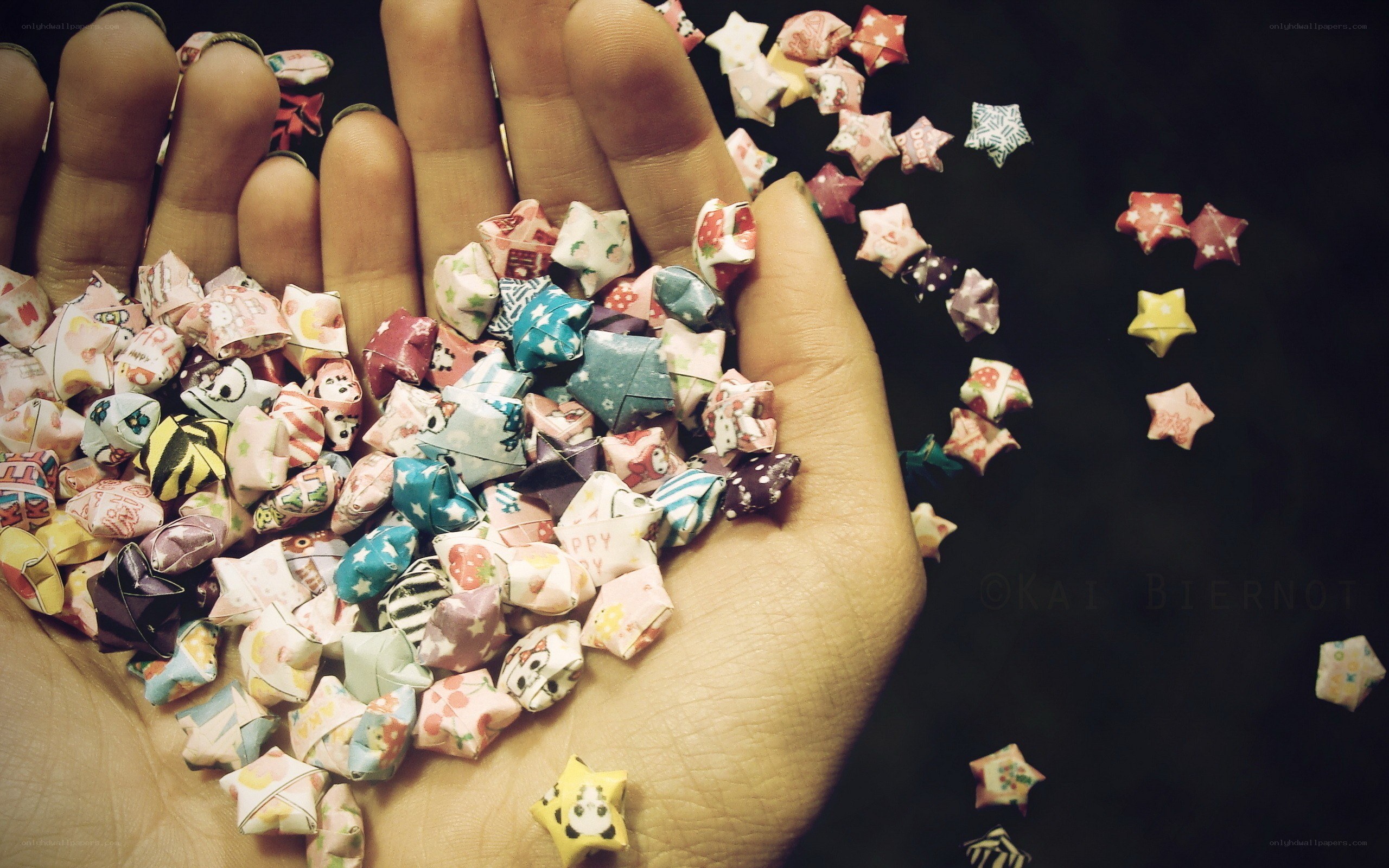 hand holding paper stars