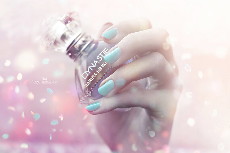 Hand Holding Perfume Bottle