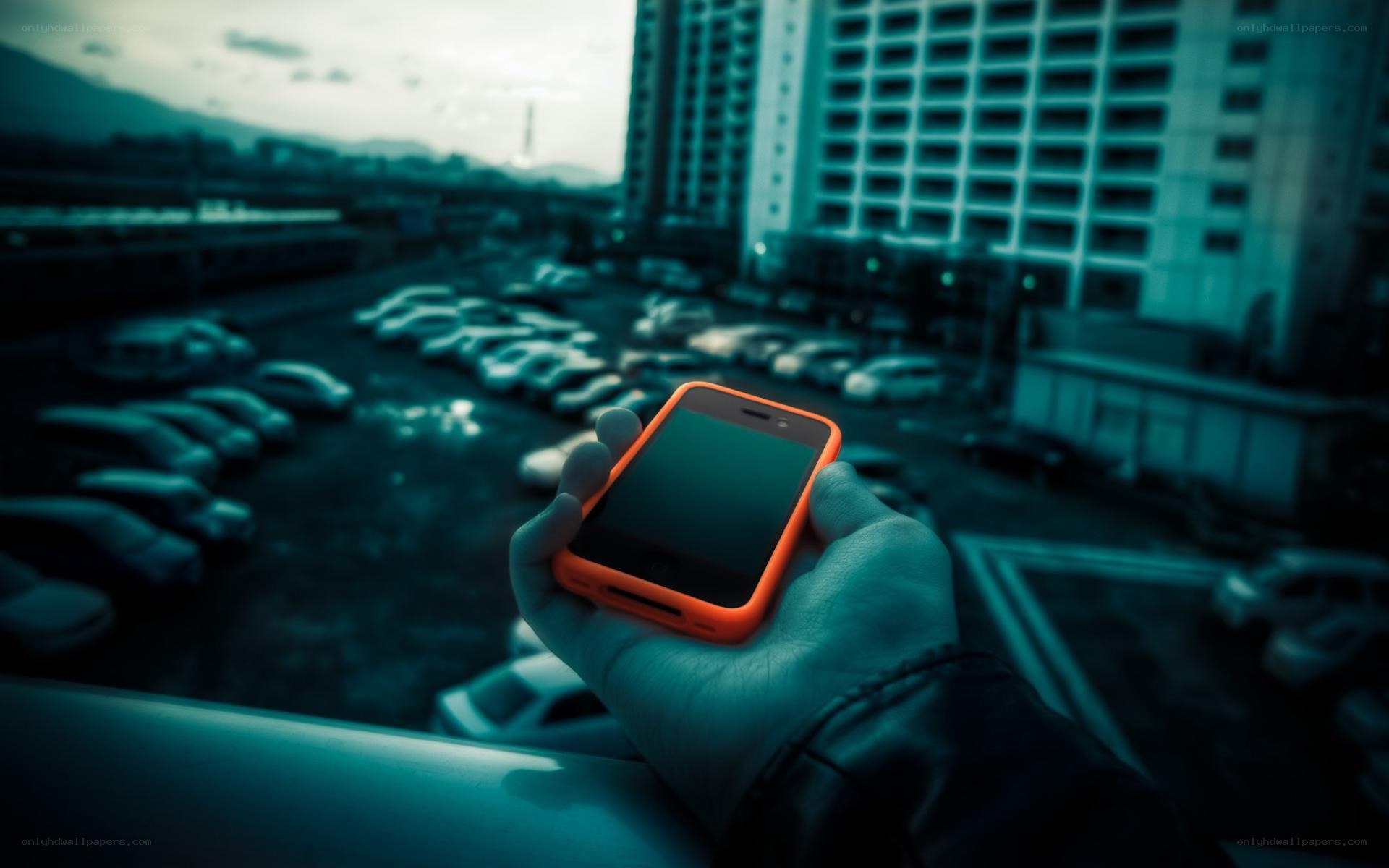 hand holding phone in city