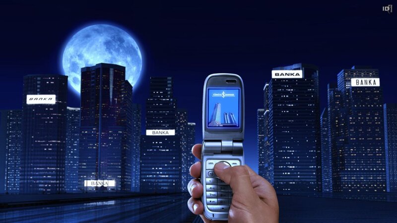 Hand holding phone in city at night