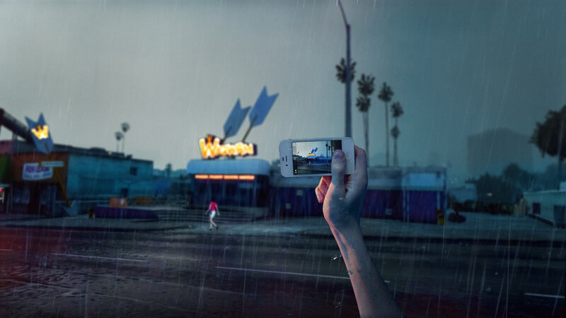 Hand Holding Phone in Rain