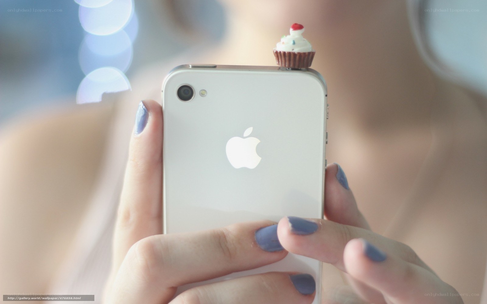 hand holding phone with cupcake charm