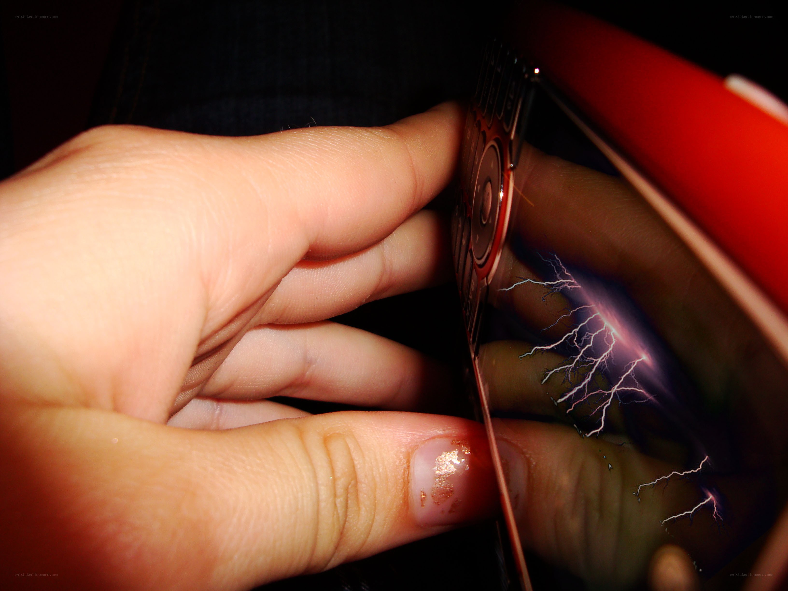 hand holding phone with lightning reflection