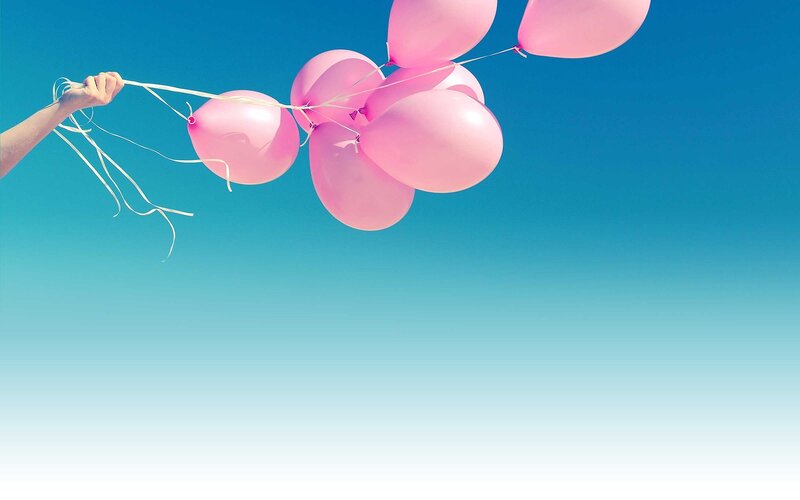 Hand Holding Pink Balloons