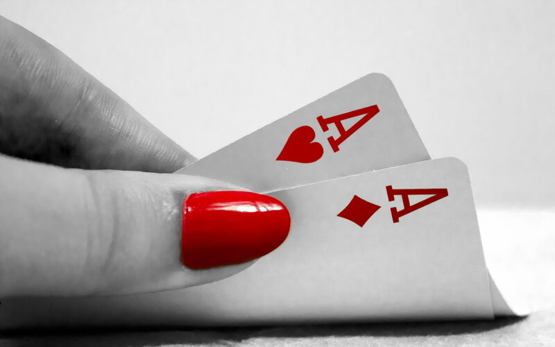 Hand Holding Playing Cards — Red
