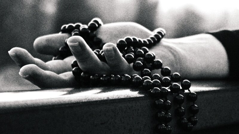 Hand Holding Prayer Beads