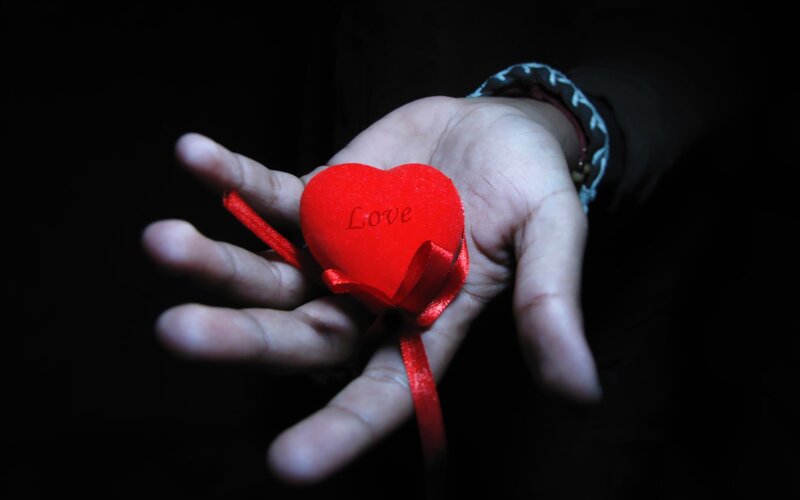 Hand holding red heart