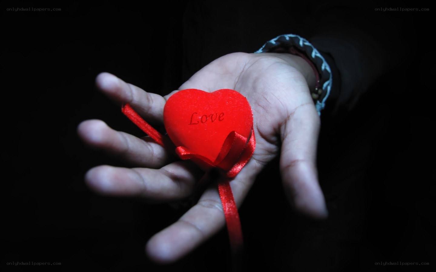 Hand holding red heart