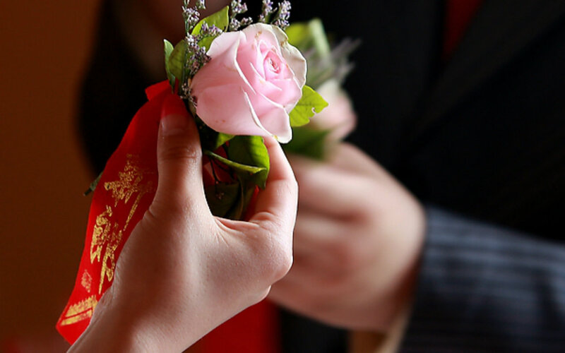 Hand Holding Rose Boutonniere