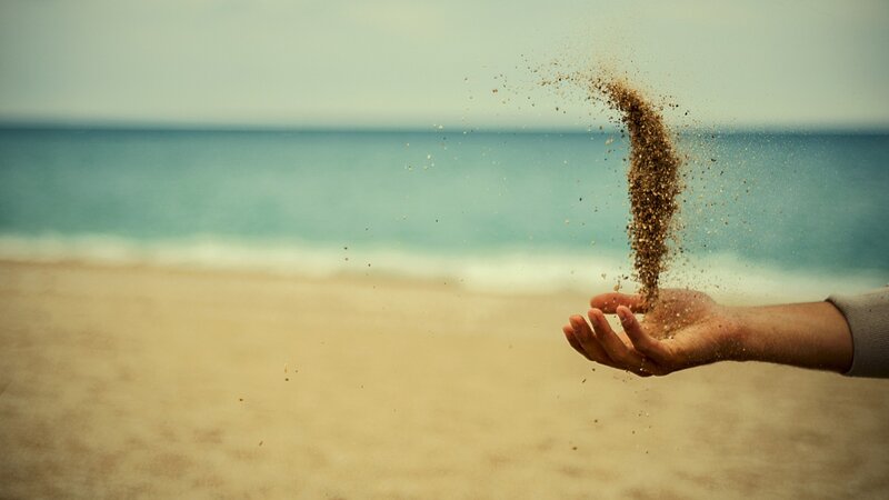 Hand Holding Sand — Brown
