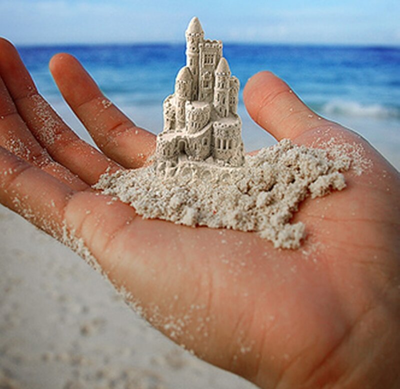 Hand Holding Sand Castle