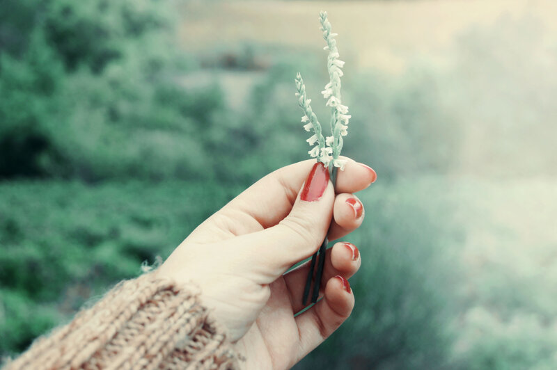 Hand Holding Small Flowers — Green, Serene