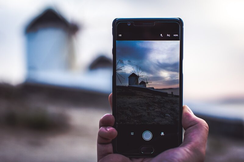 Hand Holding Smartphone — Blue, Dramatic, Sunset