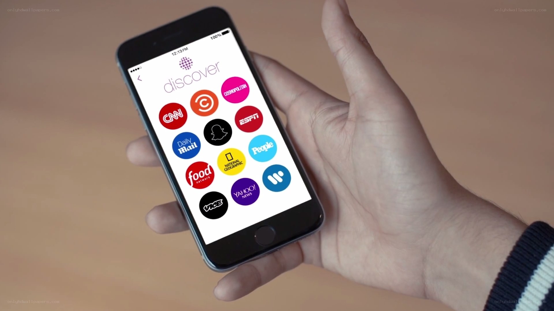 hand holding smartphone with app icons