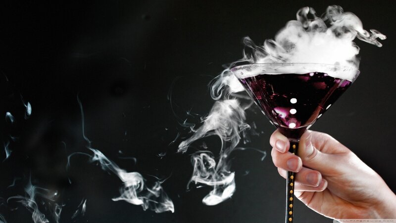 Hand Holding Smoking Cocktail
