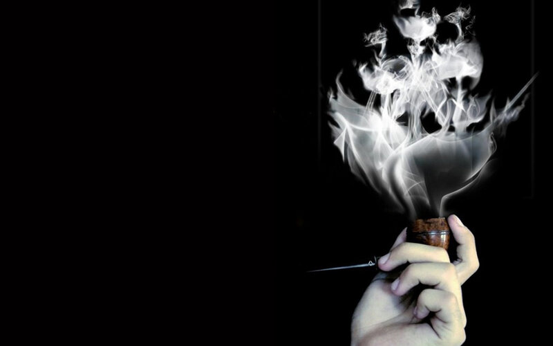 Hand Holding Smoking Pipe