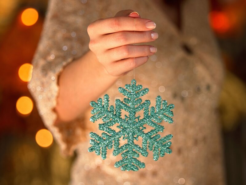 Hand Holding Snowflake Ornament