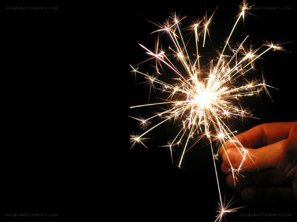 hand holding sparkler at night