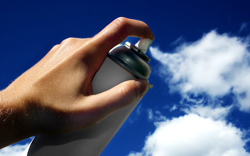 hand holding spray can