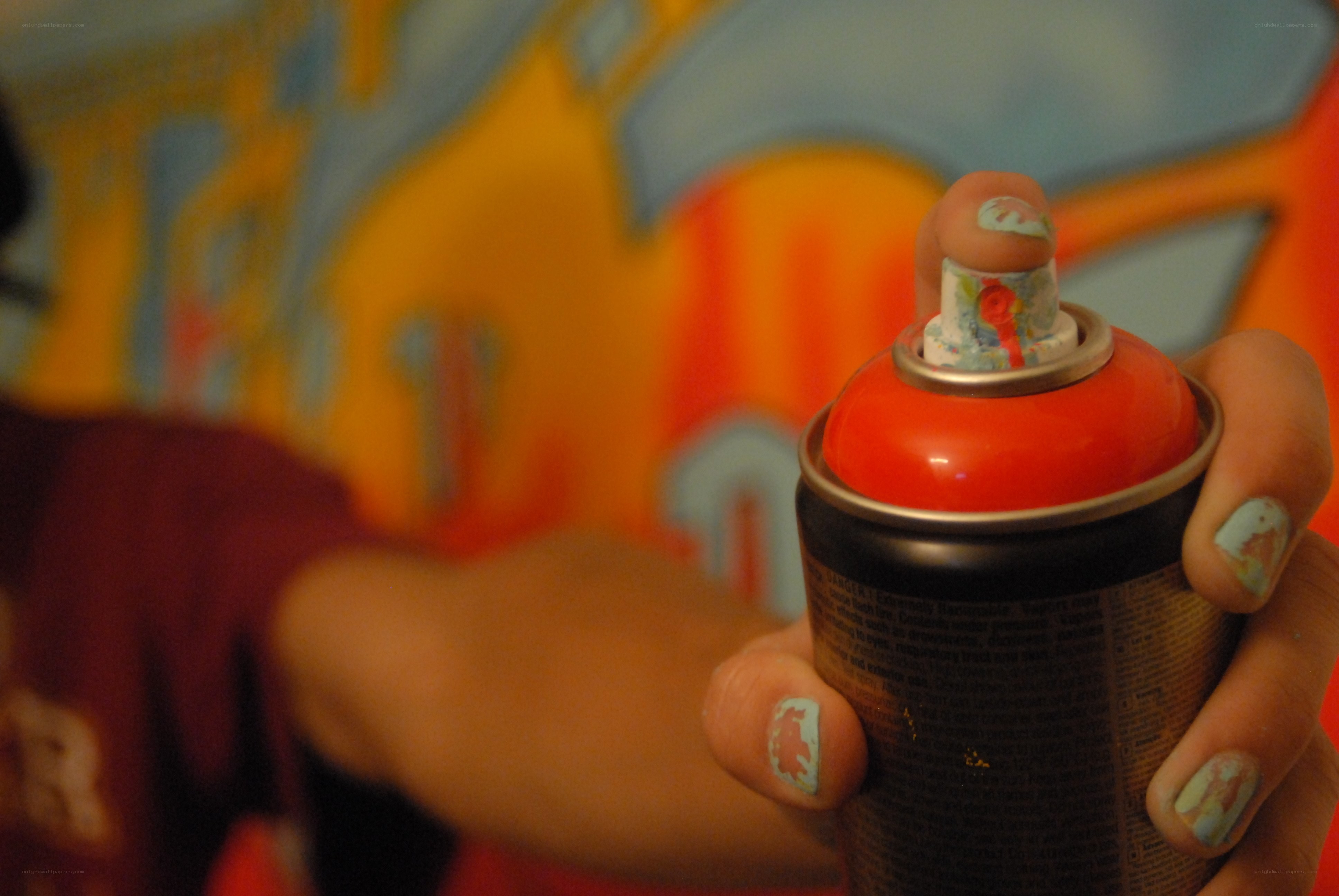 hand holding spray paint can