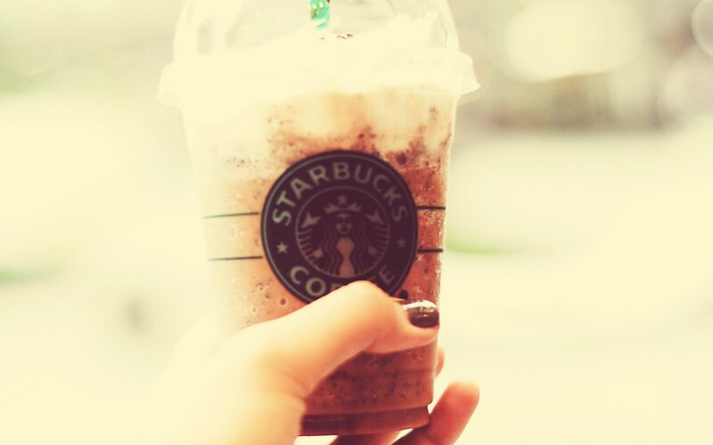 hand holding starbucks drink