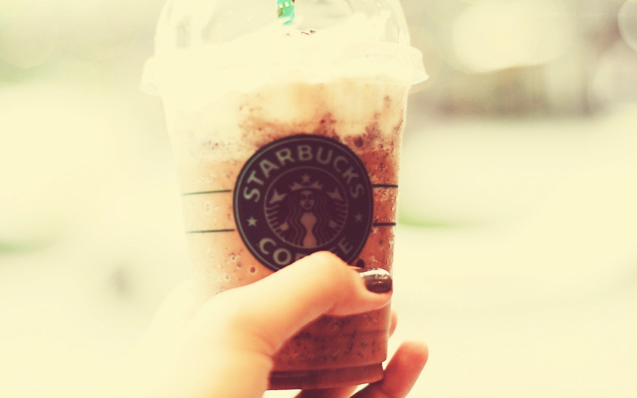hand holding starbucks drink