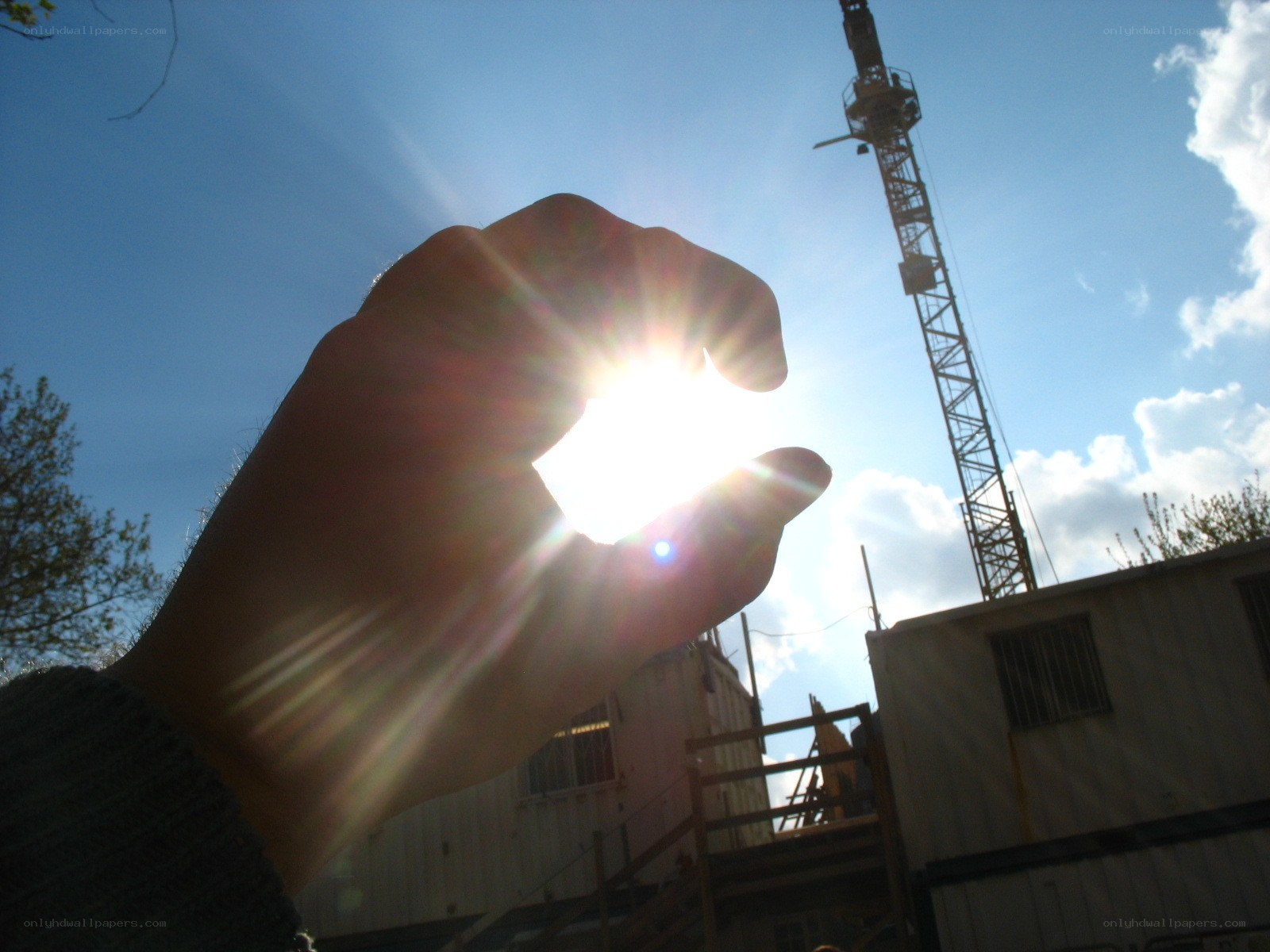 hand holding sun at construction site