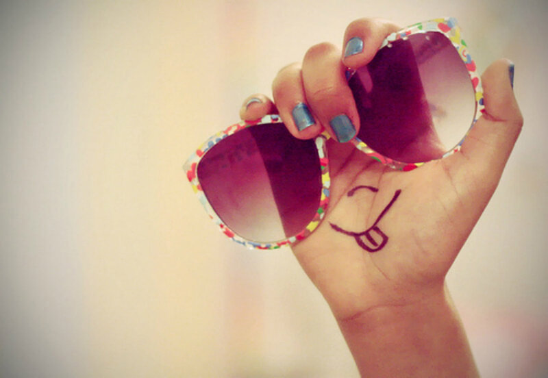 Hand Holding Sunglasses — White