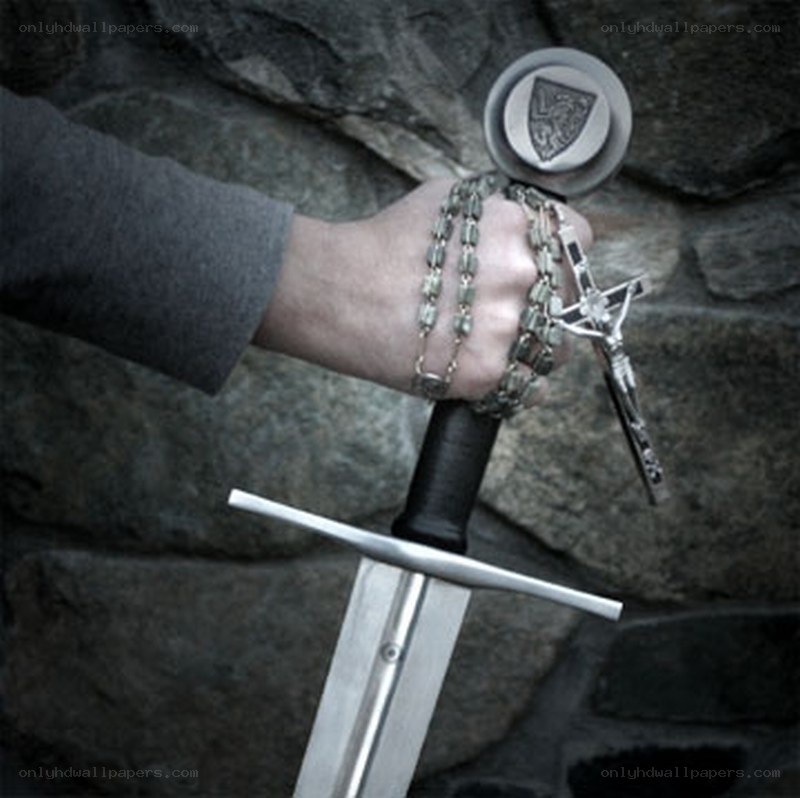 Hand holding sword and rosary